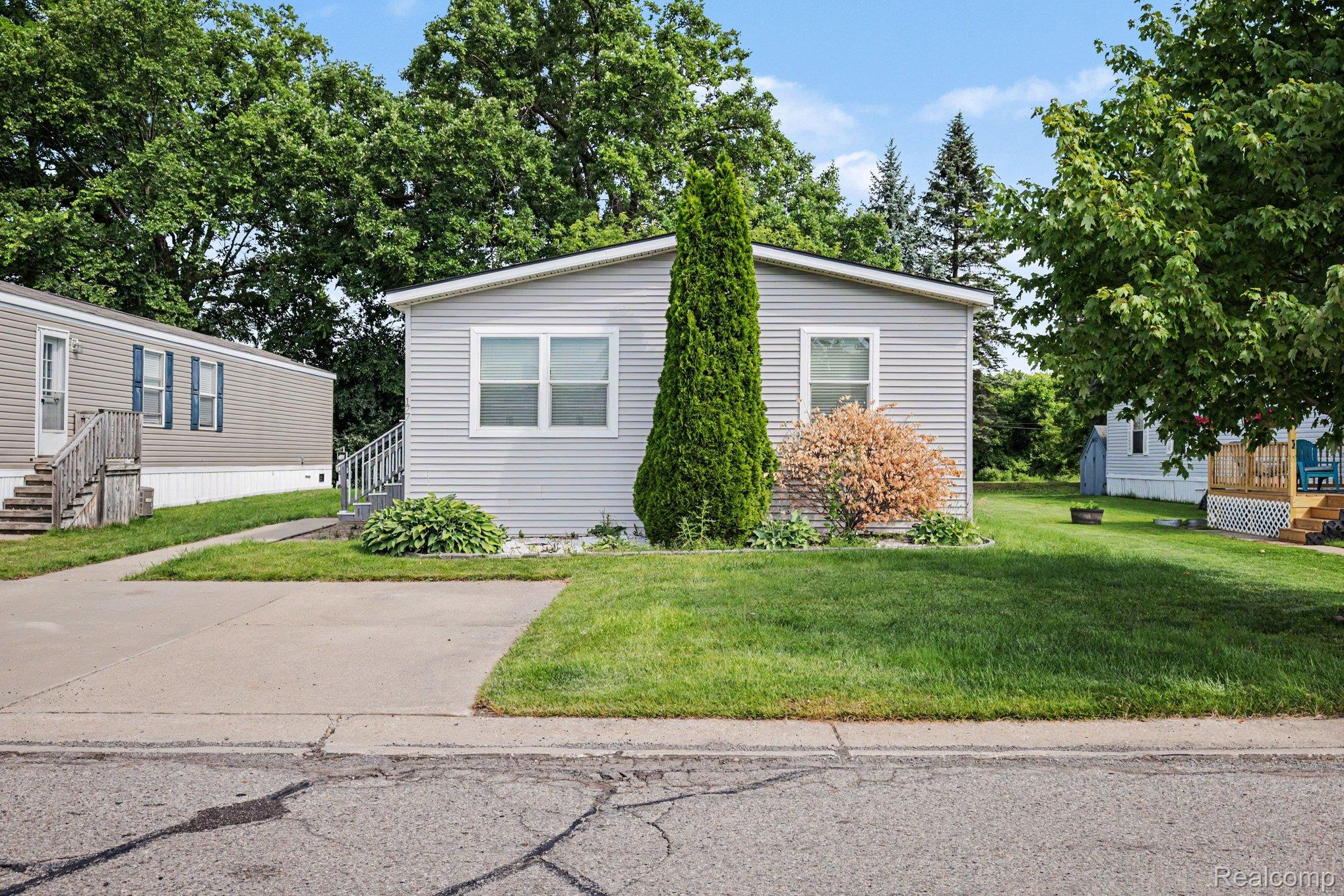 Gray siding exterior with white trim windows