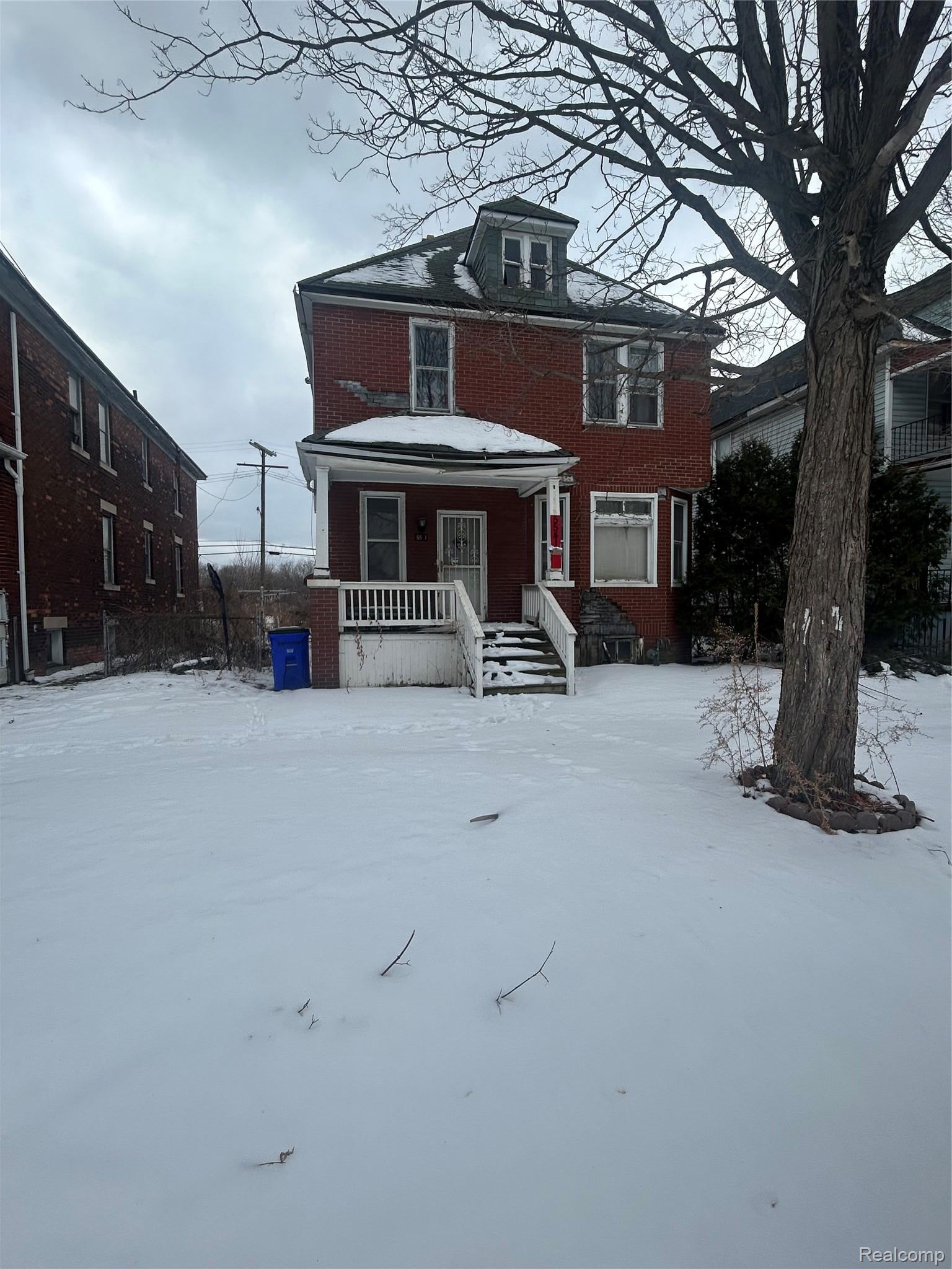 Traditional style home featuring a porch and brick siding