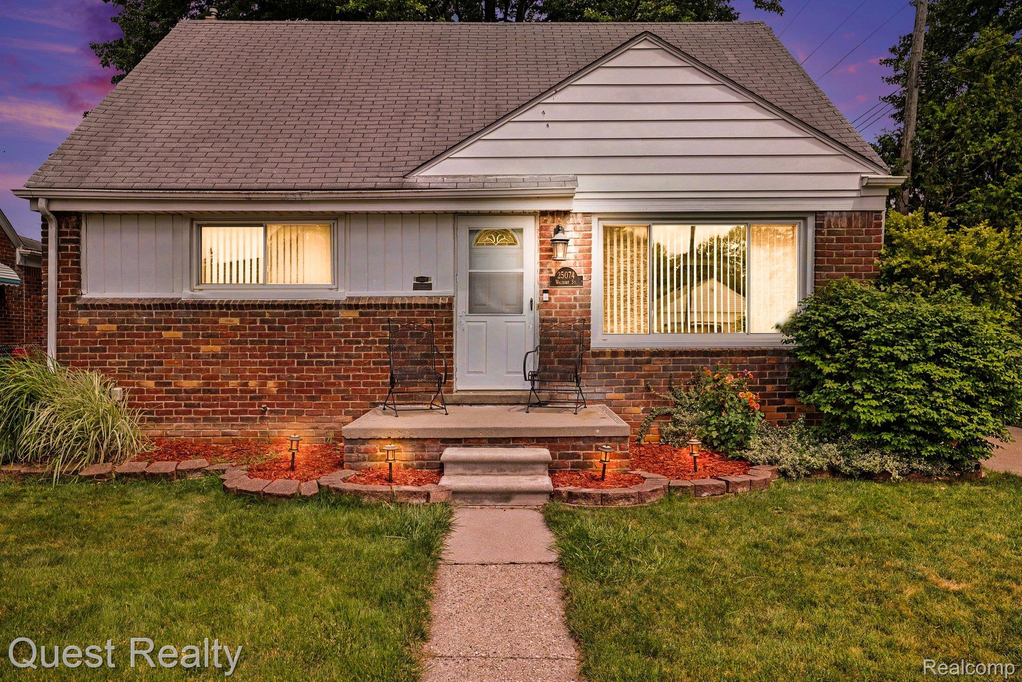 Brick and siding exterior featuring a covered entry