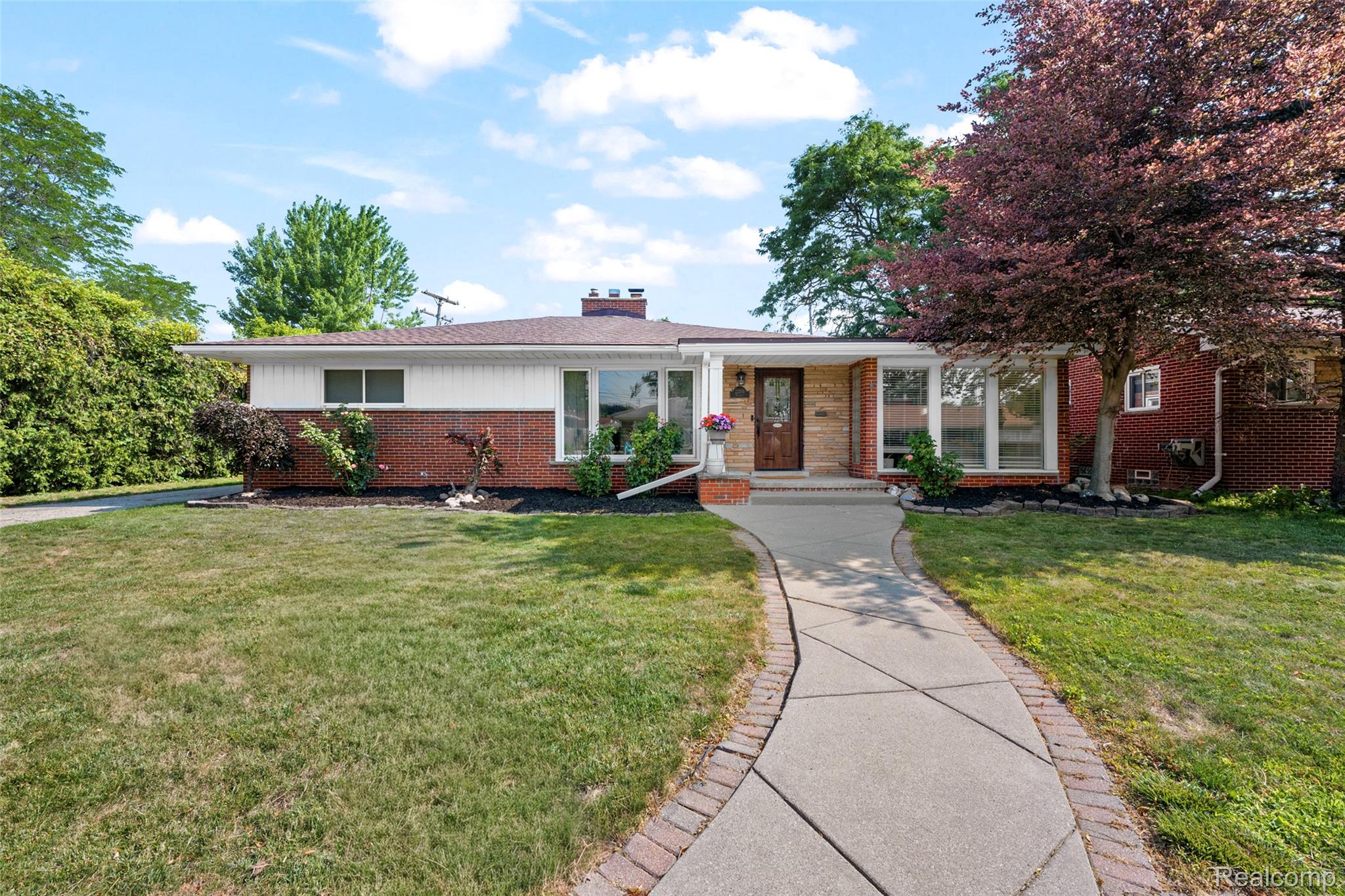 Brick and siding ranch-style exterior with a contrasting roofline