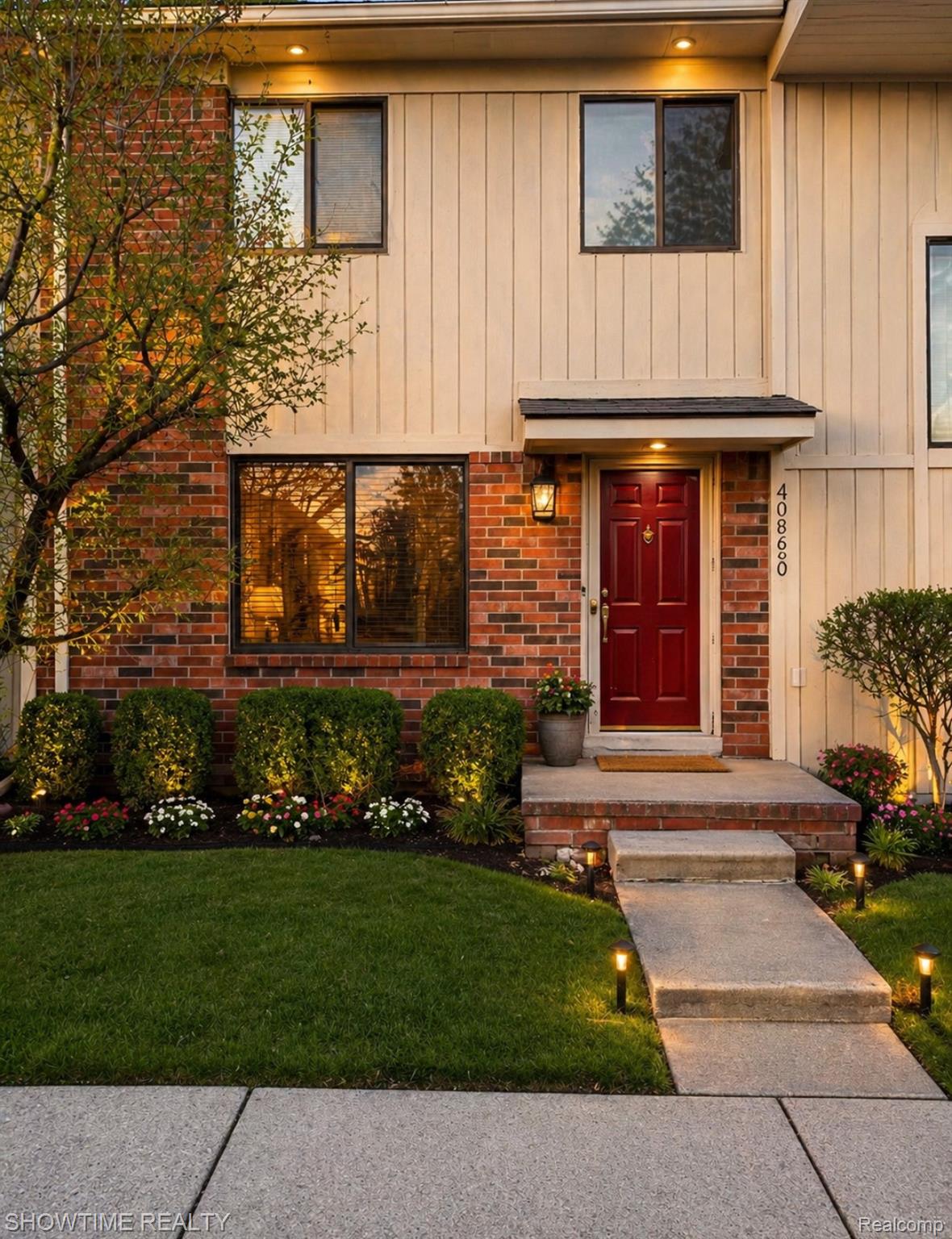 Entrance to property featuring brick siding and a yard