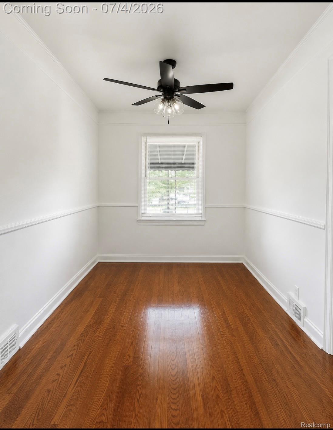 Hardwood flooring extending throughout the room