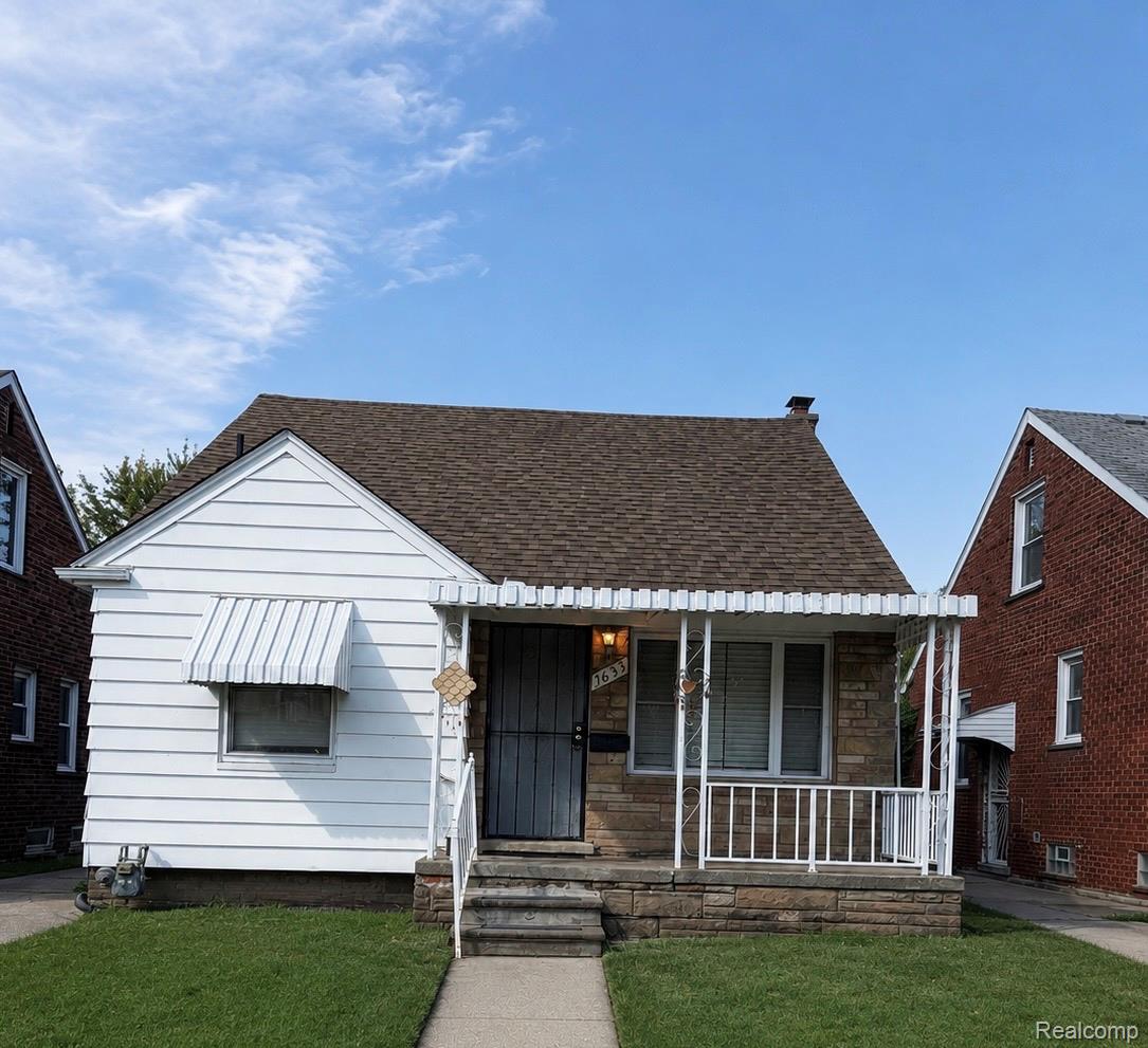 Front exterior with white siding, stone fa?ade, and a pitched roof