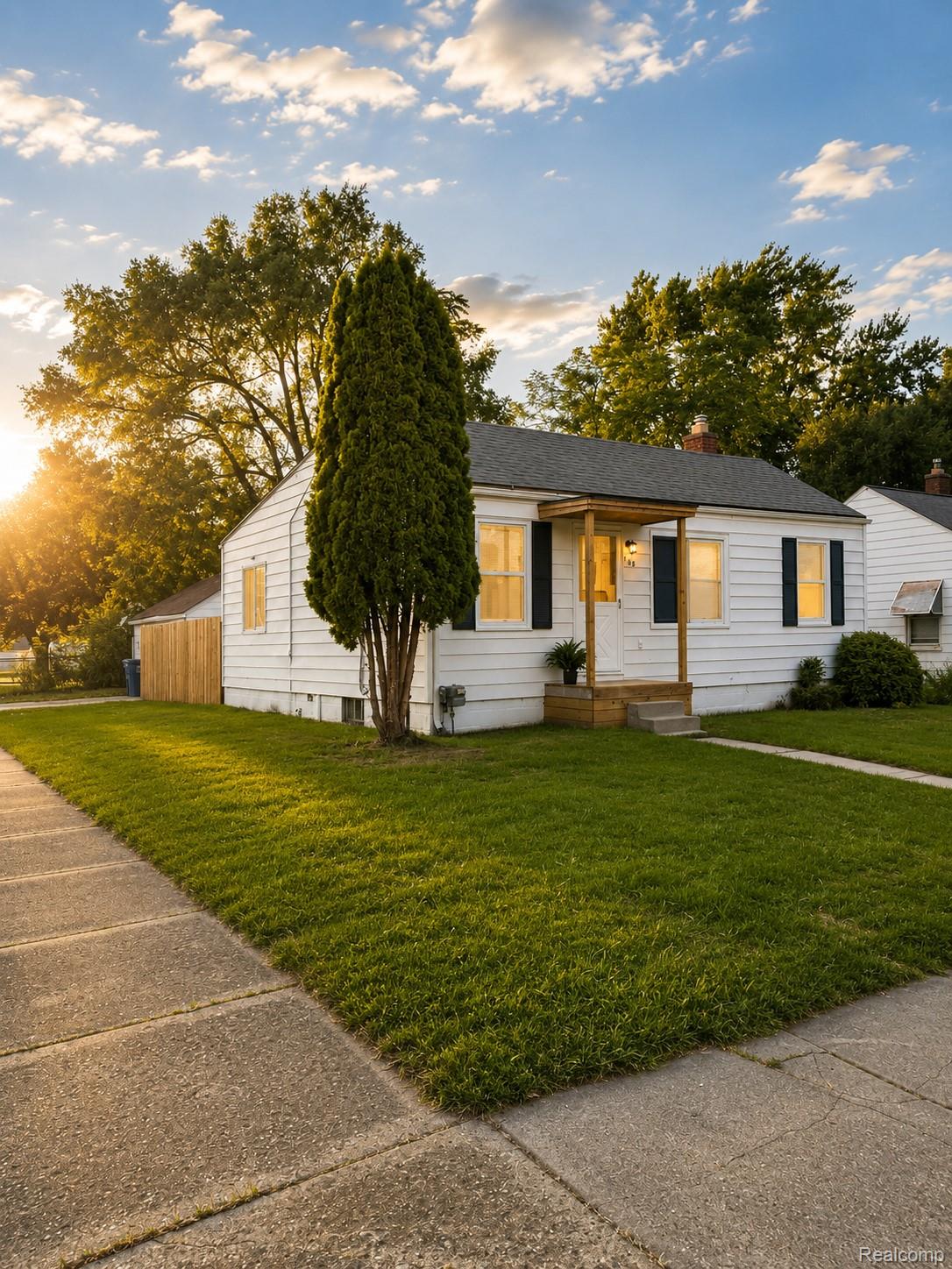 White exterior with black window shutters and a covered porch