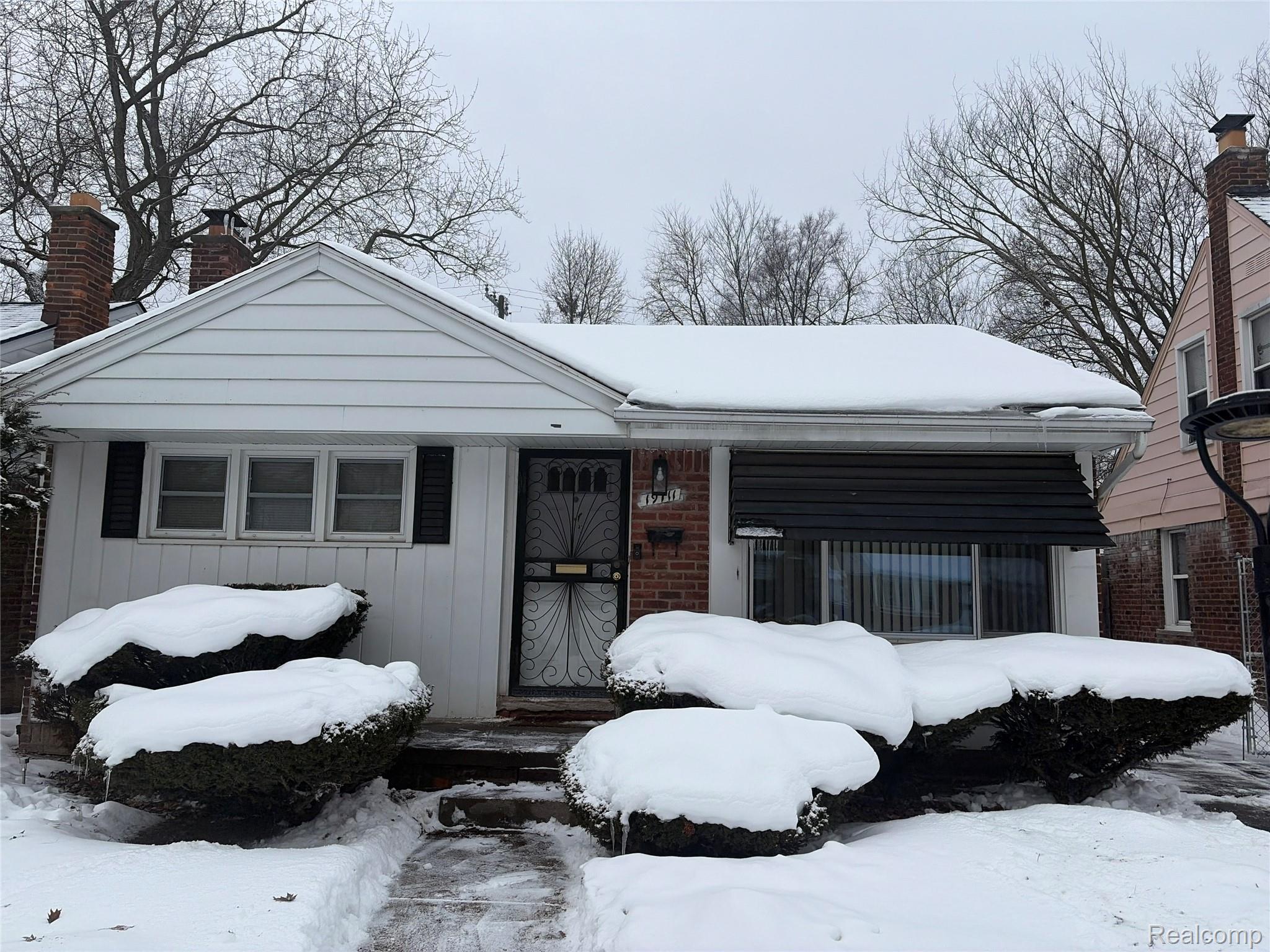 View of front of house featuring a chimney and board and batten siding