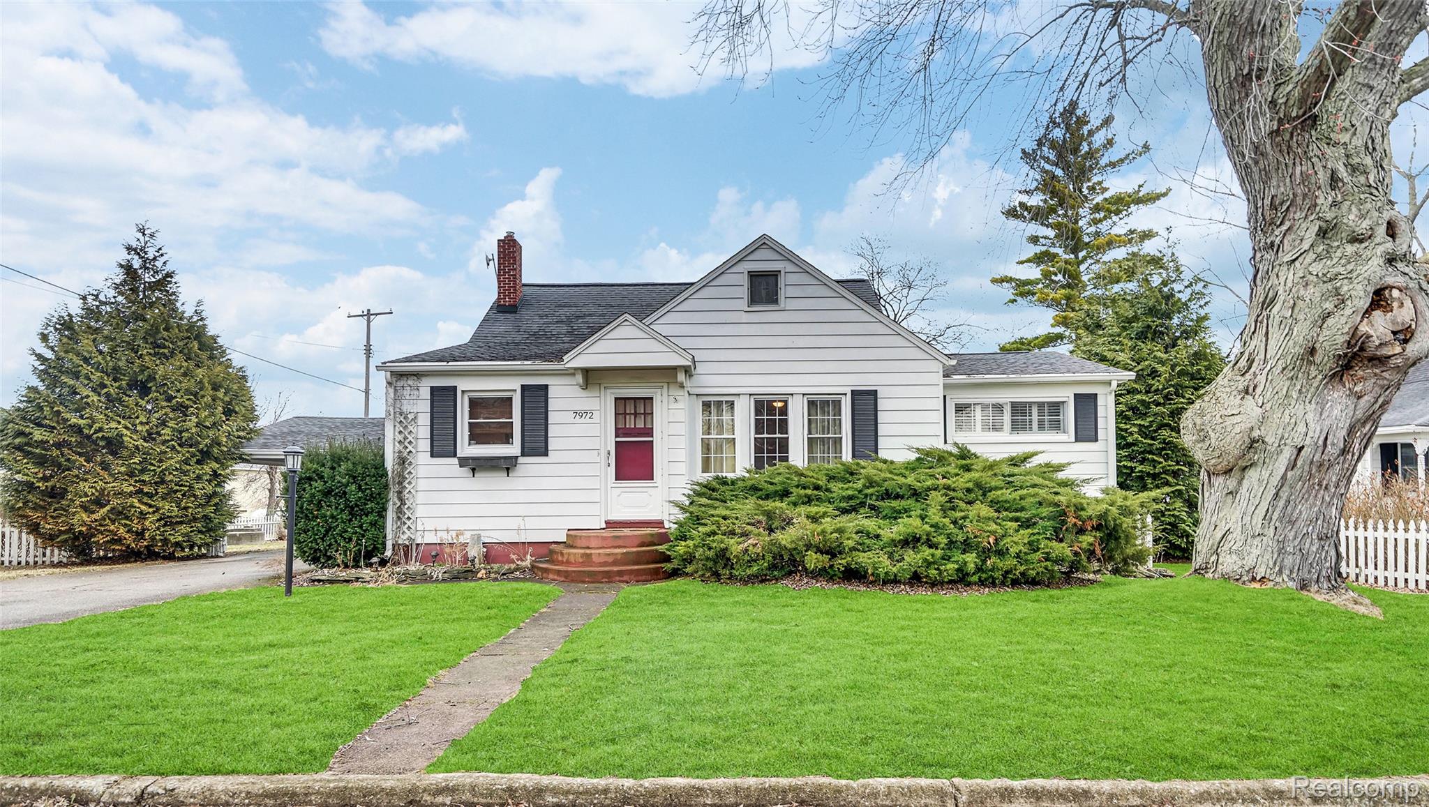 Bungalow-style house featuring a chimney