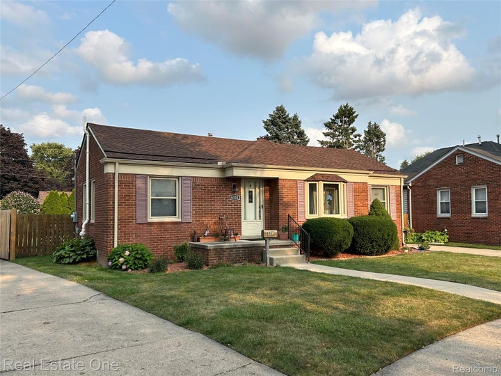 Brick exterior with a gabled roof and bay window