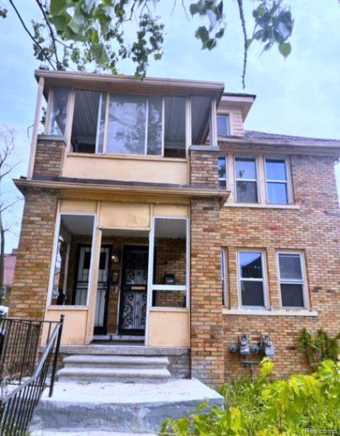 View of front of home featuring brick siding