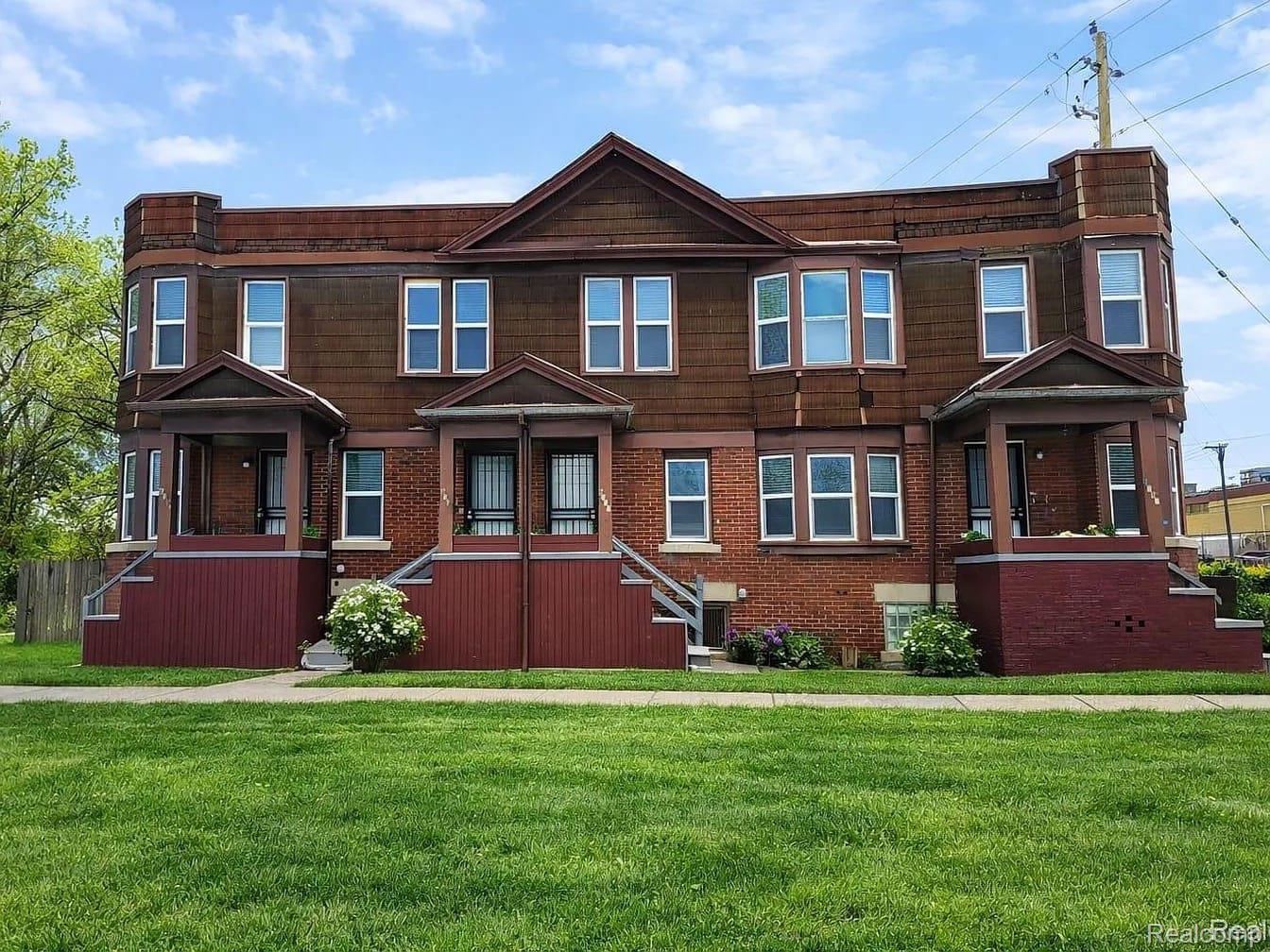 Brick and shingle facade building with multiple bay windows