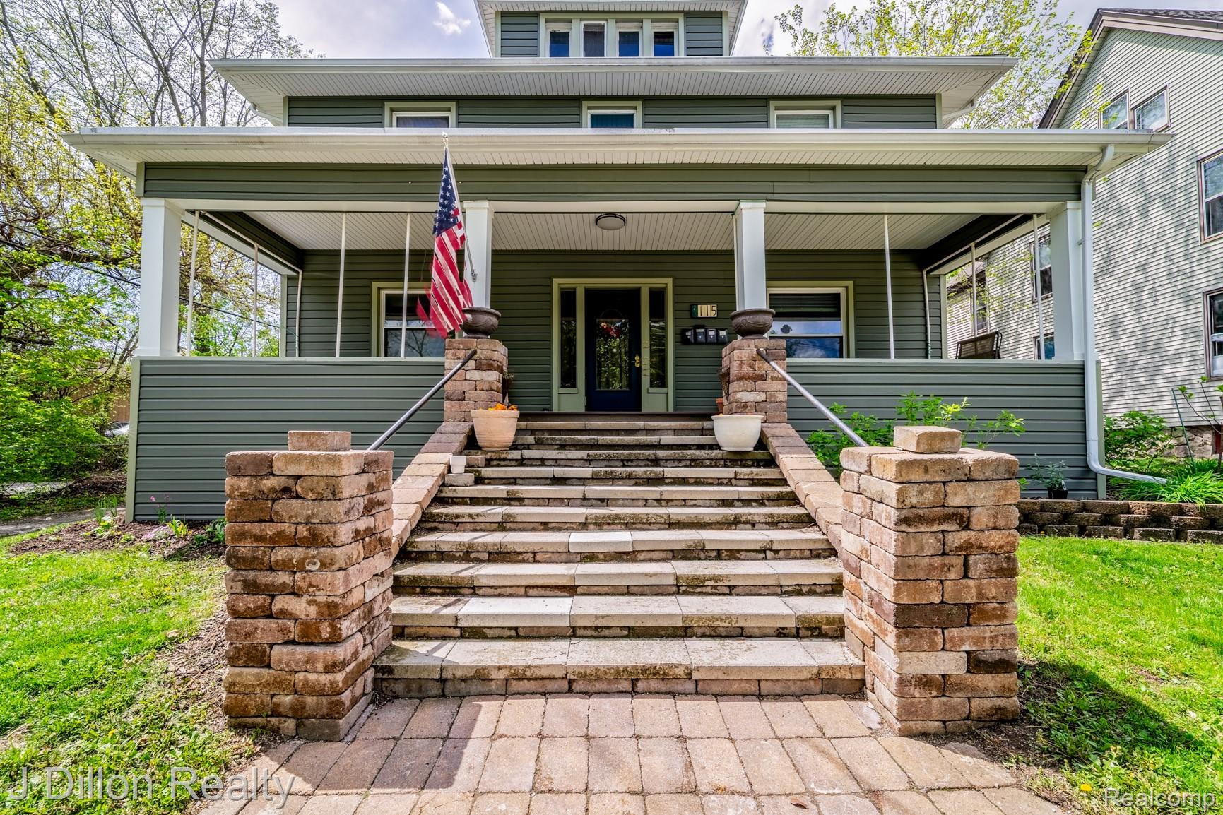 Traditional style home with a porch and stairway