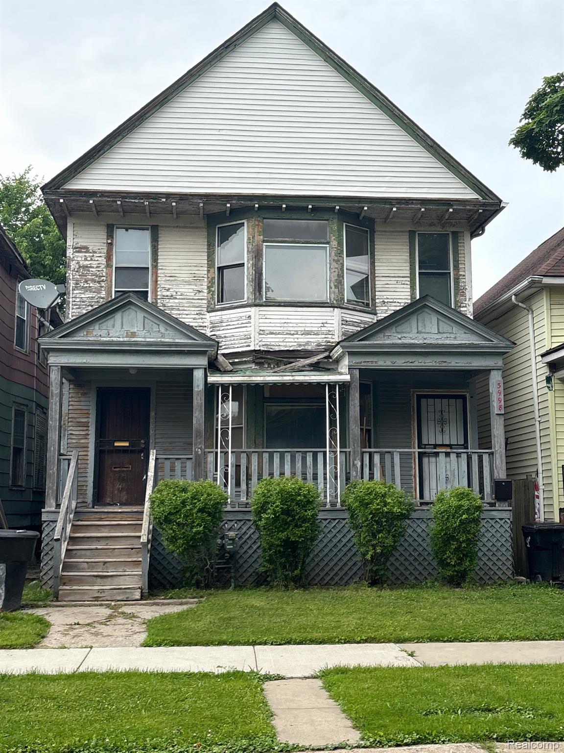 Two-story property featuring a prominent front gable and a bay window on the second level