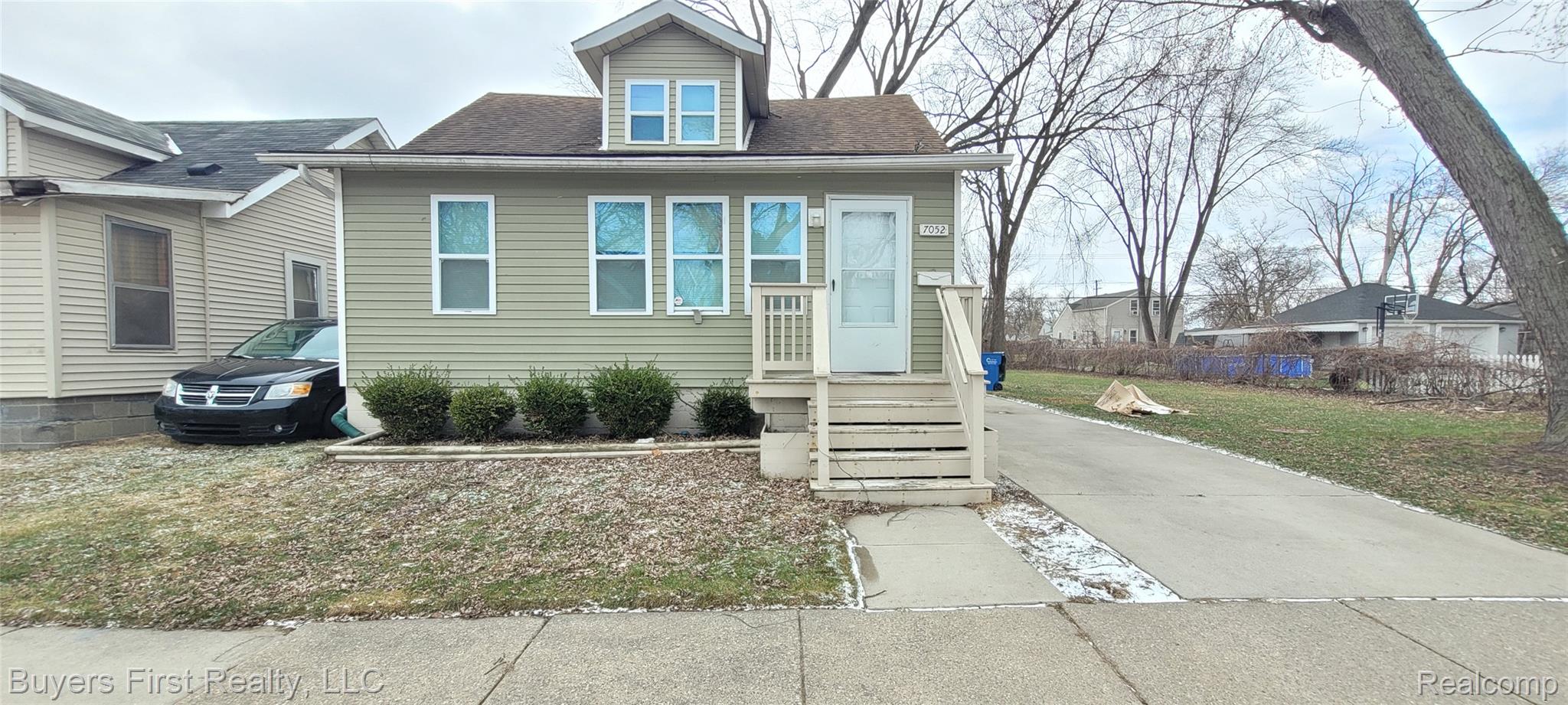 View of front of house featuring a front yard and roof with shingles