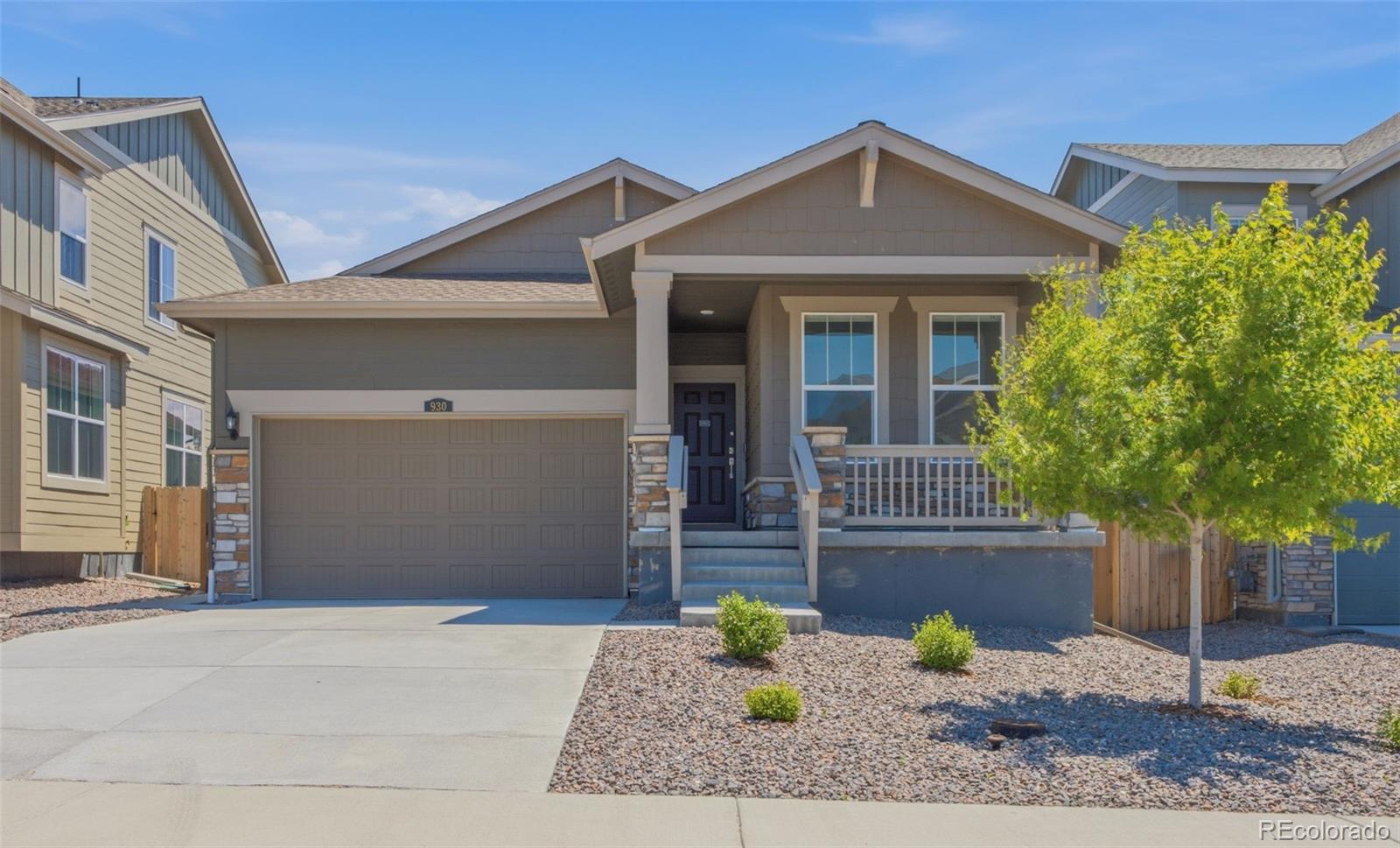Front of the home showcasing the covered porch and attached two-car garage.