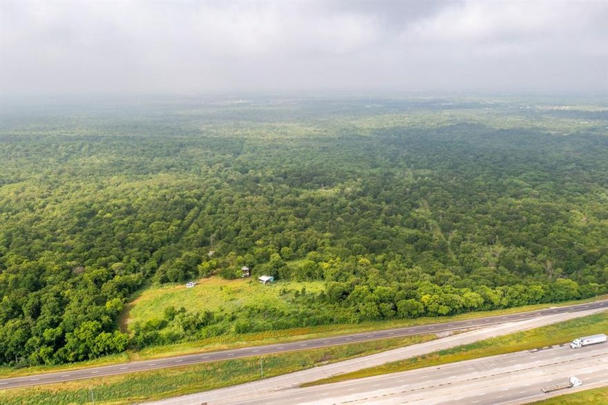 This 28-acre parcel of land is located in Navarro County, situated off of Interstate 45 between Dallas and Houston near Richland. Located in a prime location offering potential for multiple uses such as residential, commercial and development, and agricultural. While the majority of the land remains heavily wooded, there is a small portion of trees that have been cleared out to provide access to the property and a path allowing convenient passage to the back of the property. All information is deemed reliable but not guaranteed. Buyer and Buyer's Agent to verify any and all information within including but not limited to measurements, exemptions, sqft, utilities, and schools. Buyer to purchase survey.