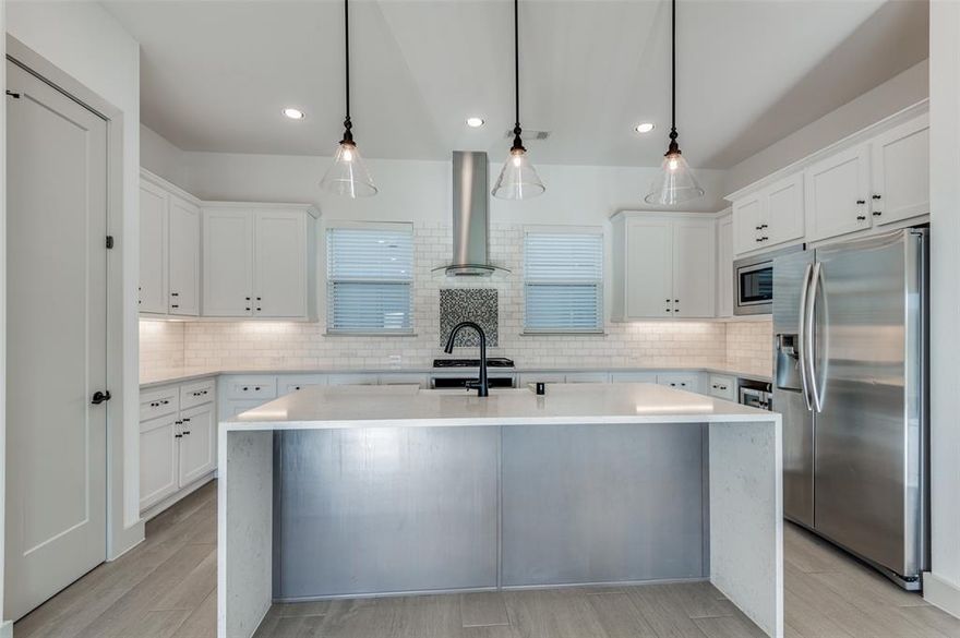 Welcome home to 2609 La Altura, a stunning three story detached residence located in the highly sought after Trinity Groves neighborhood. Thoughtfully designed and filled with custom upgrades, this three bedroom, three and a half bathroom home effortlessly blends modern luxury with everyday comfort, setting it apart from the rest of the community. Hardwood floors flow seamlessly throughout the entire home, creating a warm and sophisticated atmosphere. The heart of the home is the show stopping kitchen, anchored by a dramatic waterfall island that serves as both a statement piece and the perfect gathering spot for entertaining. The primary suite offers a true retreat, complete with a spa inspired bathroom featuring custom finishes and his and hers walk in closets, providing generous storage and an elevated sense of luxury. Each additional bedroom includes its own ensuite bath, offering comfort and privacy for guests or family members. The crown jewel of this home is the expansive rooftop patio, where breathtaking and unobstructed Dallas skyline views create an unforgettable backdrop. Relax with a glass of wine at sunset, enjoy morning yoga, or host an incredible rooftop gathering. On the ground level, a fenced in yard provides a private outdoor space that is ideal for pets. Beyond the home itself, the community amenities are nothing short of exceptional. Residents enjoy access to a resort style swimming pool, a fully equipped fitness center, a bowling alley, a stylish clubhouse, and so much more, bringing a luxury lock and leave lifestyle right to your doorstep. Perfectly located just minutes from Downtown Dallas, acclaimed dining, shopping, and entertainment, 2609 La Altura offers the ideal combination of location, design, and lifestyle. This is a home you truly have to experience in person. Schedule your showing today!