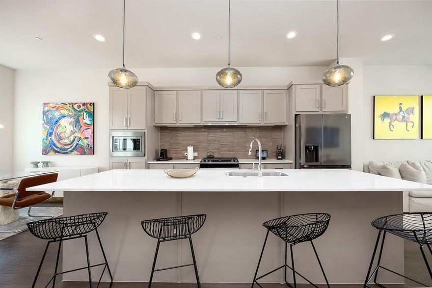 Wonderful townhome, contemporary modern style, with 2 large bedrooms plus a flex room or office, 3 bathrooms, with private rooftop. Large windows highlight the stylish open-concept space with modern kitchen premium finishes such us quartz countertops, huge island, custom cabinets and expansive windows. Hardwood floors all over the townhome no carpets, luxury finishes throughout. First floor boasts bedroom with in-suite bathroom with walk-in shower. This can be a guest room, second primary or an office. Spacious primary bedroom suite featured on 3rd floor with large sitting area, walk-in shower + separate soaking tub, walking closet and dual sinks. Flex space can be an office, gym or a 3rd small bedroom. Dallas views on your expansive private rooftop with dinning and seating area. All light fixtures have been upgraded. Two car garage in the unit and storage. All within a few minutes of entertainment districts, of Lower Greenville, Knox-Henderson, Downtown, Uptown and Deep Elum. Fridge, washer and dryer are included on the lease price.