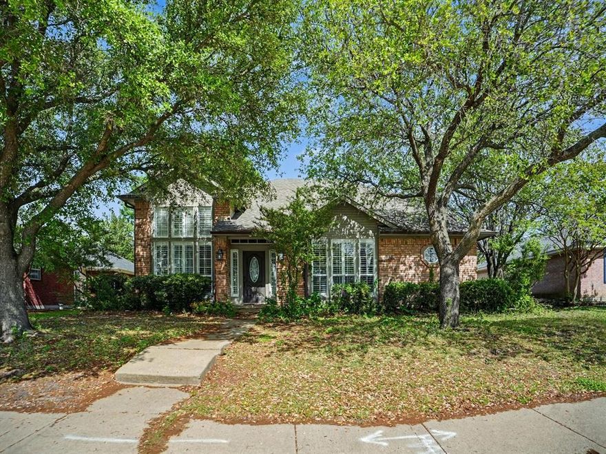 Welcome to this beautiful 4-bedroom, 3.5-bath home with a 2-car garage featuring rear alley access. Step into the inviting living room with soaring 14-ft ceilings, plantation shutters, a gas fireplace, TV mount, and built-in cabinetry. The kitchen offers an island with stainless steel top, granite countertops, stainless sink with pot filler, 6-burner gas range, dishwasher and cozy eat-in area. The spacious primary suite fits a California king and features an ensuite with double sinks, garden tub, separate shower, linen storage, and a large walk-in closet. A convenient half bath and utility room with hamper and nearby laundry chute add function. Upstairs includes 3 bedrooms, 2 full baths, and a versatile landing space ideal for an office or second living area. Ceramic tile downstairs, wood stairs, and carpet upstairs. Ceiling fans throughout. Enjoy a fenced backyard with mature trees and a storage shed.