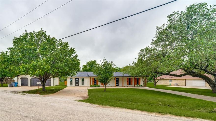 This stunning, like new, mid-century modern home offers stylish living with a flowing ranch-style layout and top-quality updates throughout. Set on two lots, it boasts a gourmet kitchen with brand-new stainless-steel appliances and matte-black finishes. The spa-inspired primary suite includes a soaking tub, spacious shower, and dual vanities. A private-entry flex suite is perfect for a home office, media room, or extra-large bedroom. Outdoor living shines with an open porch overlooking peaceful countryside views and frequent wildlife. An oversized 3-car garage on a separate lot adds convenience, storage, and its own patio retreat, connected to the home by a walkway. The property features its own well for irrigation and a newly installed septic system. Completely renovated inside and out, the expansive lot offers plenty of room for outdoor entertaining. A truly elevated property—see Private Remarks for the full list of upgrades.