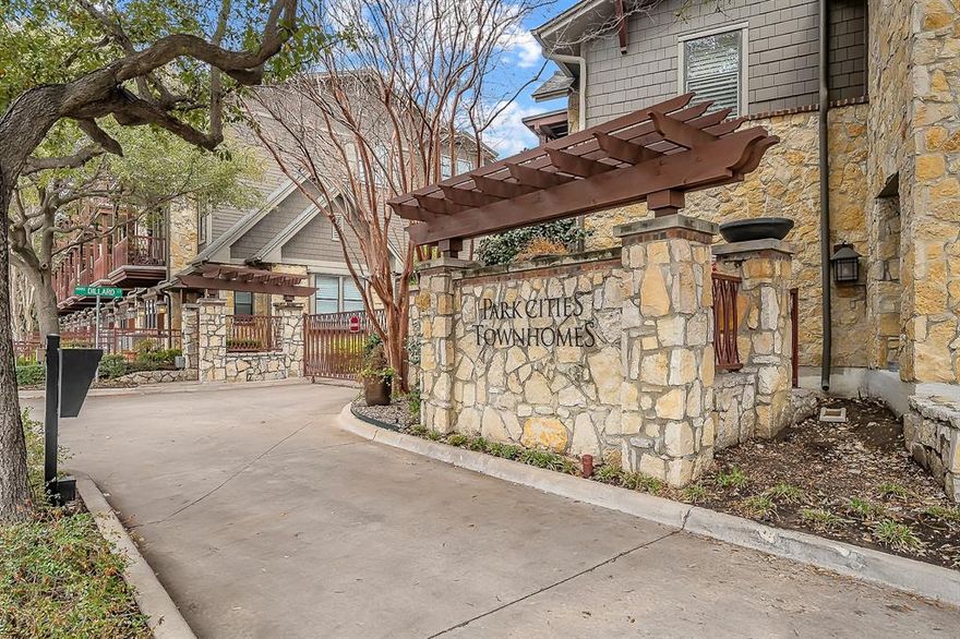 Located in a private gated community in one of Dallas’ most convenient locations, this beautifully updated three-story townhome offers a rare combination of privacy, thoughtful upgrades, and true lock-and-leave living. The community recently completed over half a million dollars in exterior improvements and features a well-maintained community pool, creating a refreshed and inviting setting. The open-concept second floor is designed for both everyday living and entertaining, featuring beautiful hardwood floors, plantation shutters, custom built-ins, recessed lighting, and access to a covered private balcony surrounded by mature trees. The kitchen is ideal for hosting with granite countertops, stainless steel appliances, a large island with breakfast bar, walk-in pantry, wine fridge, trash compactor, and built-in warming drawer. The spacious primary suite features vaulted ceilings, a private balcony, dual custom walk-in closets, and an ensuite bath with jetted tub, stacked-stone shower, and dual vanities. A first-floor bedroom with full bath offers flexibility for a guest suite, office, or study, while the third bedroom also includes its own private bath. Additional highlights include detailed plaster walls, six-speaker in-ceiling sound system, wired AV cabinet with Bluetooth, mounted TVs, washer, dryer and refrigerator (all convey), Nest thermostat, Brinks digital security system, Culligan whole-home reverse-osmosis triple-filtered water system, fenced front yard, and a two-car attached garage. Conveniently located minutes from Highland Park, Oak Lawn, UT Southwestern Medical Center, Love Field, Downtown, and all major highways.