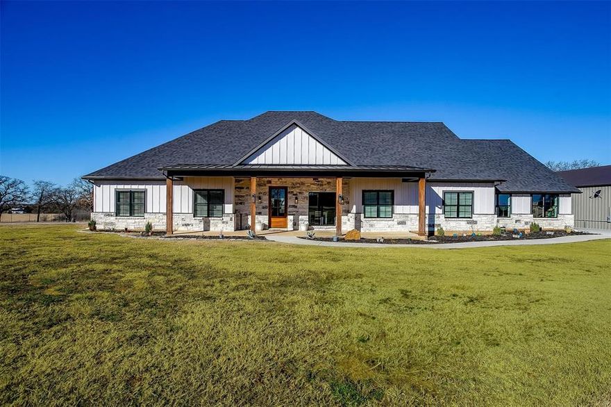 **MAJOR PRICE REDUCTION** Discover your dream home nestled on nearly 5 acres of serene land in the charming town of Joshua, Texas. This spacious 4-bedroom, 2-bathroom residence offers a blend of comfort and elegance, perfect for families or those seeking a peaceful retreat. As you step onto the large front porch, imagine sipping your morning coffee while enjoying the tranquil surroundings. Inside, the open-concept living area is designed for modern living, featuring a stunning stone fireplace that serves as the focal point of the room. Built-in shelving provides ample space for your favorite books and decorative items, while abundant natural light floods the room, creating a warm and inviting atmosphere. Culinary enthusiasts will appreciate the large kitchen, complete with a generous island and breakfast bar—ideal for casual dining and entertaining. The walk-in pantry offers extensive storage space, with room for an extra fridge, ensuring you have everything you need at your fingertips. The primary bedroom is a private sanctuary with an ensuite bathroom that boasts dual vanities, and a walk-in shower equipped with two shower heads, offering a spa-like experience at home. Three additional bedrooms provide plenty of space for family or guests, sharing a well-appointed full bathroom. An office space is also available, perfect for working from home or pursuing personal projects. The home includes a 3-car garage, providing ample storage and parking space for vehicles and recreational equipment. With nearly 5 acres of land, you have the canvas to create your outdoor oasis. Whether it's a garden, pool, or outdoor entertainment area, the possibilities are endless.