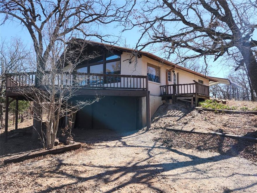 Lake View!!!! 3 bedroom 2 full bath Brick home with Metal roof with open floor plan. Home sits high on its lot with a beautiful Lake view out the huge picture frame windows. Beautiful wood vaulted Ceiling, large tile flooring through out the home. Enjoy the view on the 32 x 18 front Deck Perfect for entertaining. New concrete sidewalk that wraps around the home. 2 car carport and a storage shed.  Front and back Drive way access with plenty of parking for all your toys at this lake house. Nearby surroundings include historic downtown Nocona, a winery, brewery and just a short drive to Saint Jo, Muenster and popular Casinos.. In magnificent North Texas hill country in the private lakeside community. Nocona Hills offers a 24-hour guarded gated community with access to two private lakes (one listed as top 5 Bass fishing in Texas)a community boat ramp and dock, as well as an 18-hole golf course with driving range, an airstrip, campgrounds with RV sites, and more. Utilities include co-op water and electric already at street. Fiber optic high speed internet is also available. A must tour to appreciate. Additional lots with lake views and great locations on the golf course are available for future build sights, come out and tour the community for full details call JD 9404433371 Club house with pool are under construction to be remodeled for the community so Exciting!!!