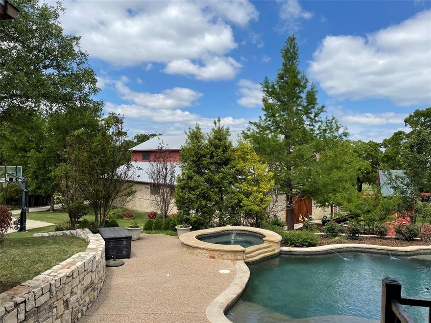 Wow!! Nearly 2 acres nestled on a quiet cul dec sac in Westlake. Come home to a dream. Private gate. Circular driveway. Stunning home and landscaping with heated pool and spa. Unbelievable 3400 square ft. barn with guest quarters up. Downstairs is an AC shop, two stalls plus tack storage and an automotive area with RV+ height garage door. This home has it all tankless water heaters, fire sprinkler system, sweeping views, heavily treed. All of it built with an 81 pier and beam quality foundation. 3 of the four bedrooms on the main floor. Guest quarters has kitchenette, full bathroom, laundry, murphy bed and living area. Truly one of a kind!!