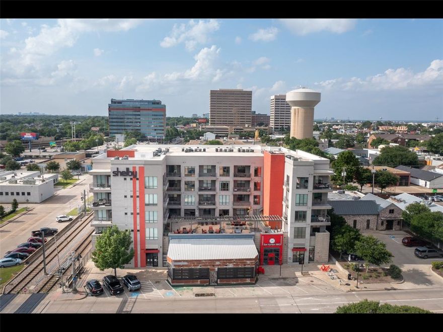 Experience elevated urban living in this beautifully maintained and lightly furnished 2-bedroom, 2-bath condo located on the fourth floor of The Shelby Residences, just minutes from SMU, Mockingbird Station, and Greenville Avenue. This light-filled unit offers a spacious open-concept floor plan and a private balcony showcasing sweeping views of SMU neighborhoods and the Dallas skyline. The sleek, modern kitchen is a chef’s dream—complete with quartz countertops, stainless steel appliances, a generous eat-in island, and ample cabinetry, making it ideal for both entertaining and everyday living. The primary suite features a walk-in closet and plenty of natural light. Enjoy resort-style amenities including secure building access, a fully equipped fitness center, owners’ lounge, rooftop terrace with lounge seating and grills, a dog play area, and much more. With proximity to restaurants, shopping, grocery stores, and the DART Rail, this condo is perfect for students, or professionals seeking comfort, style, and convenience in one of the most desirable locations. The washer dryer is not included. Covered parking for 1 automobile, with additional parking in the front and on the side  or across the street of the Dart Rail.