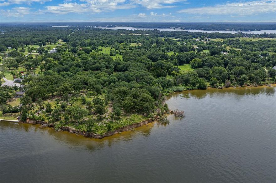 Discover the ultimate lakefront paradise on 25.5 acres with over 450 feet of stunning shoreline on deep, open water. This exceptional property, surrounded by mature trees, offers endless possibilities for a private lake estate, family compound, or prime development opportunity. Now is the perfect time to plan your dream lake living, just a little over an hour from Dallas. Enjoy a quick getaway without the hassle of travel, and create lasting memories in a place designed to suit your every need. Plans are available—seize this rare opportunity to build your ideal lake retreat.