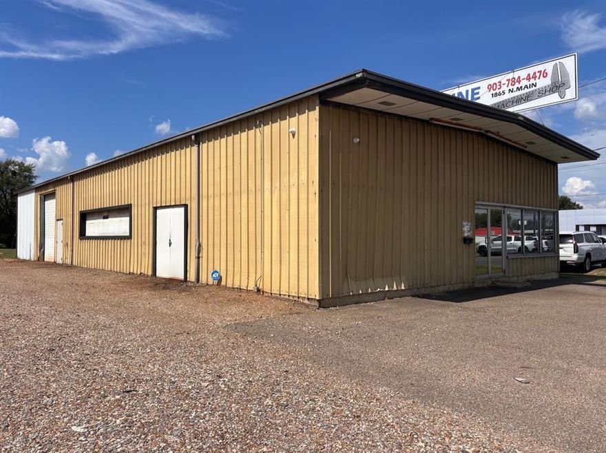 Highly visible commercial building sitting on almost an acre in an excellent location with quick access to the Loop.   Shop is 95 X 40 and features 3 overhead doors,  2 side doors and main front entrance.   Loft area and separate shop restroom.  The office area connects to a one bedroom apartment with one full bathroom and shower.   Three AC units.  Two for the shop area and one for the office and apartment.   Good space and parking for a variety of business opportunities.