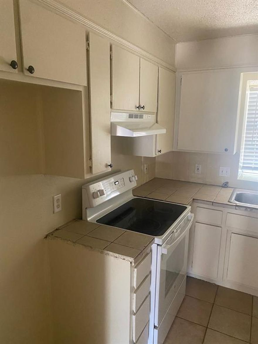 large 2 bedroom townhome . full size washer dryer connections , both bedrooms and full bath upstairs . 1 covered parking spot ,  owner pays water , sewer, trash . and lawn care . Tenant pays electricity only. Tenants provide refrigerator.