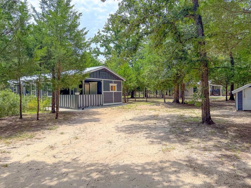 Country charm meets versatile living on 2 acres, Welcome to your slice of Texas freedom. Just minutes from 145 and outside city limits! This 3 bedroom, 2 bathroom home sits on two beautiful acres, half cleared, half lightly wooded - offering privacy, space, and room to grow. The layout features a spacious primary suite with an attached bonus room that can serve as a home office, nursery, or creative flex space. From this room, step out to a covered porch area -perfect for quiet mornings or relaxing evenings. Behind the main home you'll find a detached in law suite featuring an open layout, bathroom, and closet. Electrical and plumbing are already in place, offering excellent potential for a guest space, rental, or studio.  The property also includes a detached outdoor kitchenette a versatile outbuilding with a window, covered sink area, and plenty of space for a refrigerator, deep freezer, or additional storage. Great for canning, hosting gatherings, or simply keeping extra appliances out of the main home. This property offers the ideal blend of peace and practicality plenty of trees for privacy, open space to build or garden, and the flexibility of being outside city limits. Whether you're looking for a quiet homestead, multi generational setup, or an income producing opportunity, this property is ready to meet your vision.