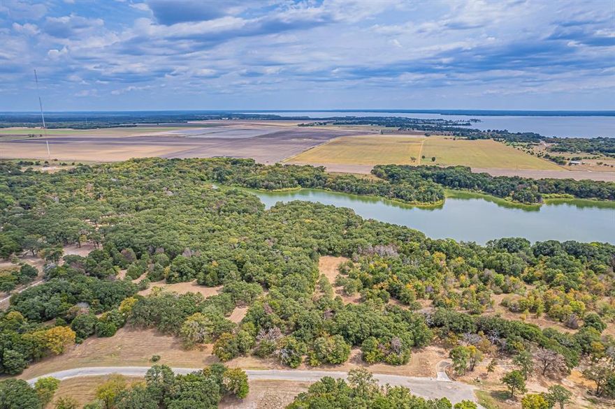 ***MOTIVATED SELLER***Beautiful water-view residential lake lot on one of the largest lakes in Texas, Richland Chambers Reservoir spreading over 41k acres. This .98-acre lot is located in the quiet and well-maintained subdivision of Sweetwater Ranch with multiple trees throughout and backs up to private farmland. High-speed fiber internet and available utilities makes this lot a nice option for building the perfect primary home or summer getaway just outside the city, south of Dallas. Take a stroll to the private dock and boat ramp to enjoy fishing, boating, breathtaking sunsets and the lake life.  Don’t miss out on this highly sought-after beautiful upscale country neighborhood. Dock and access.