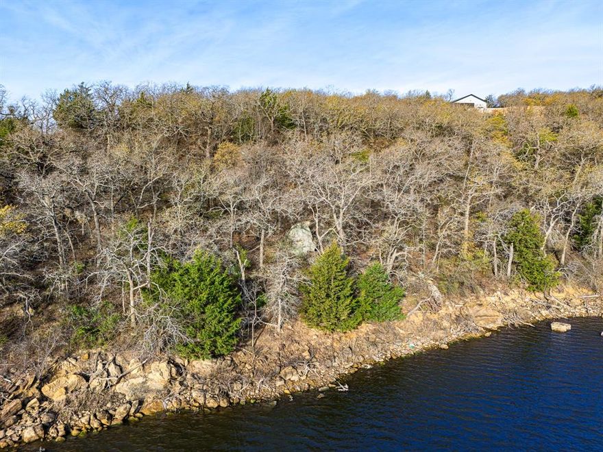 These 2 waterfront lots are a nature lovers retreat, it is heavily treed with large natural rock formations that slopes down to the water of Amon G Carter Lake, which is known for great fishing.  Affordable waterfront lots are hard to find so do not let this opportunity pass you by.