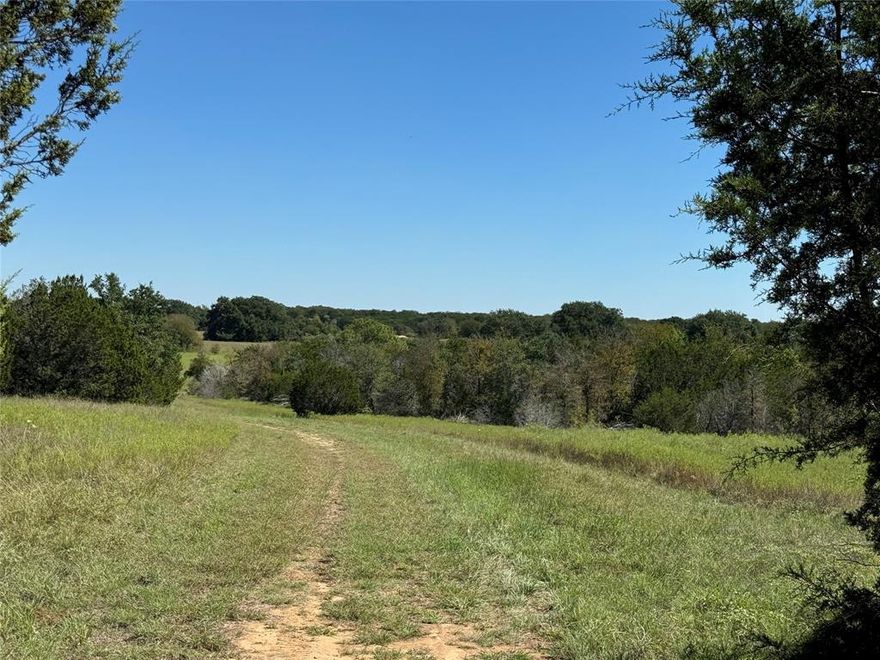 This beautiful 145+ acre ranch south of Cleburne offers limitless potential, set amidst a diverse landscape rich with wildlife. Featuring dense woods, open fields, a serene pond, and direct access to the Brazos River, this property is perfect for your dream project. With multiple build sites, it's perfect for those seeking tranquility and natural beauty. Rolling hills and valleys provide breathtaking views of the peaceful countryside. The ranch is equipped with on-site electricity, including an RV hookup, and will need a water well and septic system for residential use. Electric and fiber internet through United Co-op. Explore the numerous ATV trails that wind through mature trees, gullies, and open spaces. Located in the picturesque Goatneck area of southern Johnson County, known for its scenic rolling hills and outdoor recreation opportunities like hunting, fishing, and hiking. Just minutes from The Retreat, Ski Ranch, and Hamm Creek Park, this ranch is ideal for agriculture, ranching, development, or a recreational retreat. The possibilities are endless!