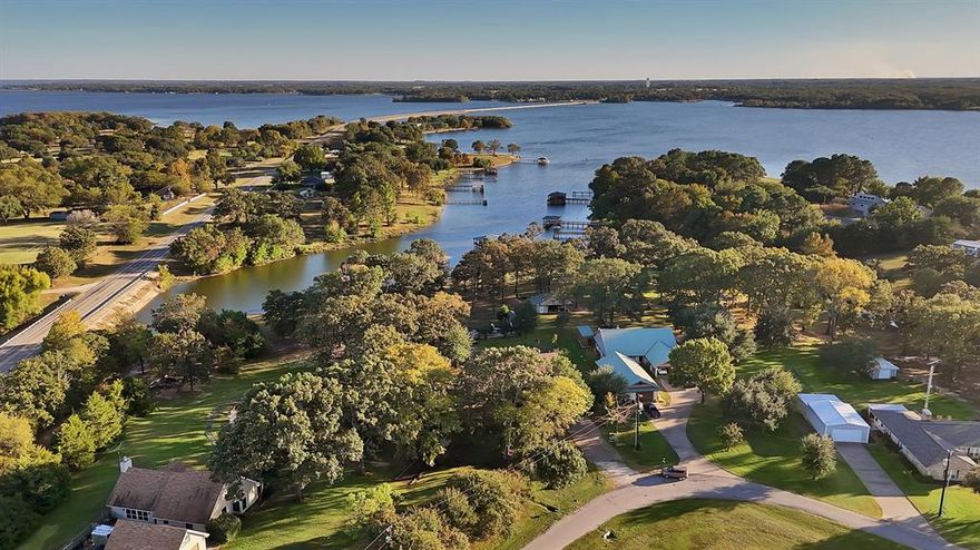 Experience the best of Lake Fork living! In the desirable Northwood community, this waterfront gem blends comfort with the tranquility of lake life. Perfectly positioned across from Lake Fork Golf Club and just minutes from the nationally acclaimed Links at Land’s End, this address places you at the heart of two of East Texas’s premier destinations. Step inside the expansive living and dining areas with soaring ceilings and a striking brick fireplace. Tile floors throughout create a seamless flow, and while the kitchen and baths invite a personal touch, every inch of this residence has been meticulously maintained and move-in ready. Enjoy thoughtful details like an oversized laundry room, ample storage, and a detached two-car garage joined to the home by a pergola-covered patio, ideal for morning coffee or evening wine. Outdoors, a fenced backyard with a pool opens to nearly half an acre of scattered trees, leading to your private covered boathouse with slip and fishing pier. Whether you’re seeking a weekend escape, an investment-ready vacation home, or a forever lakefront retreat, this property captures the effortless beauty and lifestyle Lake Fork is known for. From peaceful mornings on the water to evenings under the Texas stars, this is lake living at its finest.