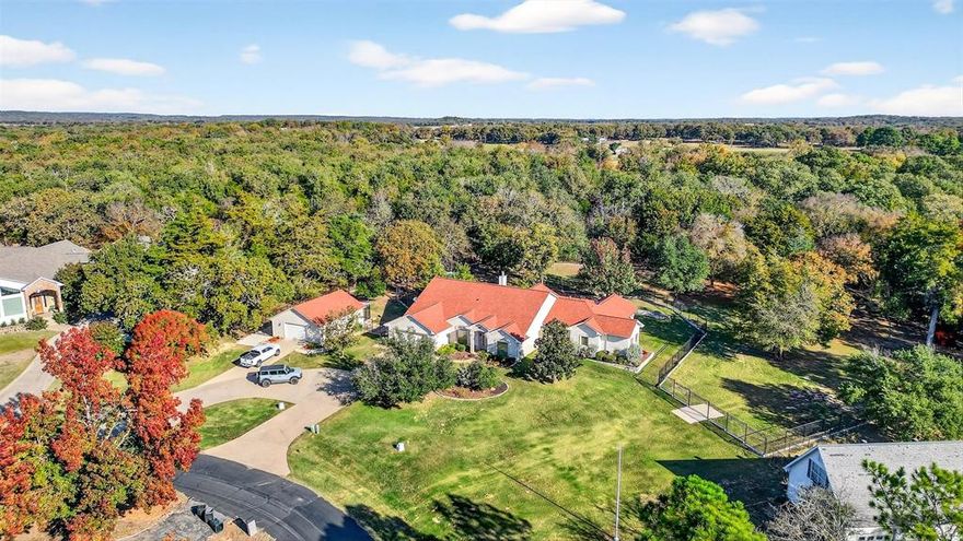 One-of-a-Kind Lake Kiowa Gem on Triple Lot with Two Master Suites. Nestled on a serene 1.57-acre triple lot on the north side of Lake Kiowa, this Southwest-style home offers privacy, space, and character at every turn. From the moment you step inside, you’ll be captivated by the custom details, beautiful tile flooring, handcrafted tree-post accents, unique sconces & formal den.The primary master suite is truly a retreat, featuring room for a sitting area, seperate vanities plus a dedicated makeup vanity, a corner jetted tub, a custom walk-in shower and an extraordinary closet complete with built-in storage, seasonal upper shelving & shoe rack. The 2nd master suite offers its own luxury touches with dual vanities, a corner tub, a glass walk-in shower & walk in closet. Designed for both comfort and entertaining, the open living area includes a brick gas fireplace, hardwood floors, a built-in coffee bar, and a wall of windows that frame views of your beautiful private backyard. The kitchen opens to the living space and features stainless steel appliances, a gas cooktop, a long breakfast bar, and abundant counter space. You’ll also find a formal dining room & a dedicated office with extensive built-ins and a built-in desk. Step outside to your backyard oasis, complete with a covered patio stretching nearly the full width of the home. Enjoy views of mature trees within your fully fenced yard, enclosed by black wrought iron fencing with concrete footers for durability. A separate dog run includes a climate-controlled dog room (which could double as a workshop) just off the secondary garage. Above the main garage, discover a air conditioned and heated game room or man cave or also perfect for a fourth bedroom, media room, or private retreat. Both garages are generously sized. With its blend of craftsmanship, comfort and privacy, this Lake Kiowa treasure is a must have. Schedule a showing today and experience all that this remarkable home has to offer.