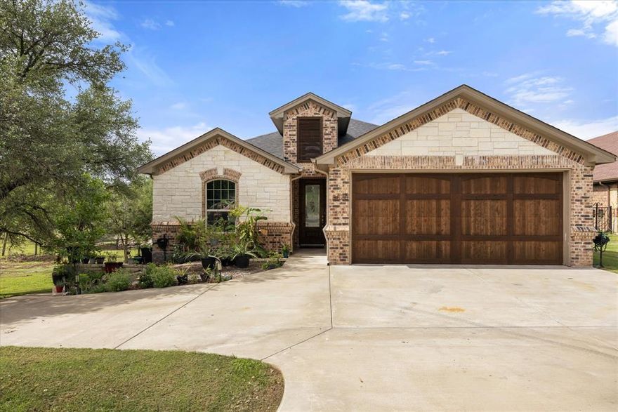 Nestled within the highly sought-after gated community of Pecan Plantation, this exceptional custom-built home offers both resort-style living and serene golf course views. Ideally positioned along #9 tee box and backing up to a beautiful pond, you’ll enjoy both privacy and picturesque scenery, all just moments from the clubhouse.

On the main floor, the home features a bright and open-concept living and dining area, and a well-designed kitchen with a grand island.  Large windows invite in natural light and frame the tranquil pond views, while the spacious upstairs deck provides the perfect setting for morning coffee or evening relaxation. The primary suite is also located on this level, complete with an en-suite bath, along with a second bedroom and full bathroom.

Downstairs offers incredible flexibility and space, currently serving as a game room and entertainment area. With its own kitchenette, bedroom, full bathroom, and large covered patio, this level could easily function as a private mother-in-law suite, guest quarters, or multi-generational living space.

The home is complete with an oversized two-car garage, as well as a separate garage ideal for a golf cart, workshop, or additional storage.

Living in Pecan Plantation means access to an unmatched array of amenities, including two 18-hole golf courses, a prestigious clubhouse, tennis and pickleball courts, two swimming pools, disc golf, archery and air soft gun ranges, an equestrian center, private airpark, a full marina with boat ramp, and more. This is more than just a home—it’s a lifestyle.

Don’t miss your opportunity to own a slice of paradise in one of Granbury’s most desirable communities.