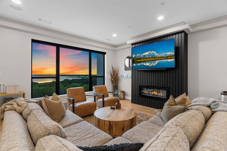 LUXURY, LOCATION, LIFESTYLE & EASY LIVING - this BEAUTY has it ALL! Minutes from many restaurants, shops, and entertainment venues at Grandscape, The Star, The PGA, HEB, Costco & the Frisco $5B mile - just to name a few! Just 3 miles to 121 and a quick trip to the Airport, Dallas, Ft Worth, & surrounding areas. Enjoy a stunning LAKEFRONT VIEW from every room along with the scenic COE land loaded with trees, meandering trails, beautiful foliage and parks. The modern architecture is defined with clean lines, natural light, large picture windows, tall ceilings, wood floors throughout along with convenient SMART HOME features. The ground floor greets you with sleek concrete flooring, tall ceilings, & leads to a flexible space that can serve as a guest suite, office, or studio—complete with its own full bath & direct access to the private garage.  On the 2nd level, the primary suite offers a spa-inspired ensuite bathroom, featuring a walk-in shower, free standing tub, double sinks, lots of storage & a custom closet. A 2nd bedroom with an ensuite bath & walk in closet complete the level, along with a laundry space tucked neatly away between the 2 rooms. The 3rd level opens up to a spacious kitchen that anchors the heart of the home with custom cabinetry, quartz countertops, & high-end appliances—all within easy reach of the open dining & living areas. Natural light floods in through large picture windows, framing glimpses of the lake and beyond. Elevate your entertaining or relaxation on the ROOFTOP PATIO with full outdoor kitchen, fireplace, TV, and its pre-wired for a hot tub. This luxury townhome is low maintenance and designed for easy living with an elevator and lock & go lifestyle. Experience the ease of city living with all the benefits and views of nature and lake life!