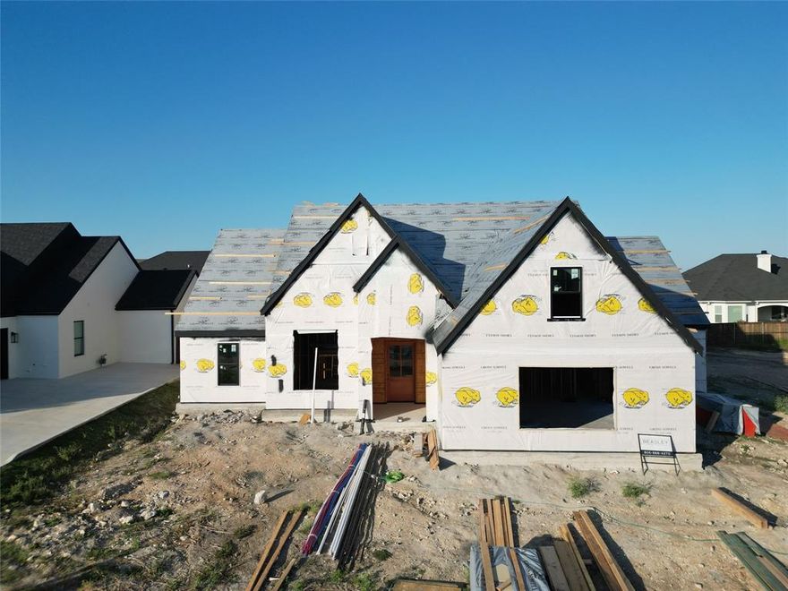 BUYER CAN CUSTOMIZE - UNDER CONSTRUCTION - PROJECTED COMPLETION FEB 2026 or EARLY MARCH.
Nestled within the prestigious Tanglewood Estates subdivision in Woodway, TX, this property offers a remarkable blend of contemporary design and timeless elegance. With 5 bedrooms, 3.5 bathrooms, and a versatile flex space upstairs, this home is a perfect match for modern family living. The heart of the home is a beautifully designed kitchen that features stainless steel appliances, modern cabinetry designs, and an island that overlooks the living room and gas fireplace. The main floor boasts 3 bedrooms, an office, and a primary suite with a luxurious shower, freestanding tub, and walk-in closet. The second floor features a flex space that can be customized to suit your lifestyle - use it as a home office, media room, or a playroom for the kids. Families residing in Tanglewood Estates have the advantage of the natural gas options, sidewalk lined streets, a 3 acre park, 1 acre pocket parks, and being a part of the esteemed Midway Independent School District. With its spacious layout, top-notch schools in the Midway ISD, and a vibrant dining scene, this property offers the perfect blend of comfort, style, and convenience for your family's next chapter.