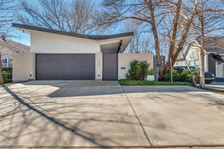 Architecturally striking and intentionally designed, 2507 Abrams is anything but ordinary. This 3-bedroom, 2-bath modern spans approximately 2,000 square feet of thoughtfully curated living space.
The compound-style butterfly design creates dramatic sight lines from the moment you enter, with soaring ceilings and walls of floor-to-ceiling glass that flood the home with natural light. Clean lines meet refined finishes, including museum-finish walls and custom primary closet cabinetry that elevate everyday living.
A substantial masonry wall frames the front of the property, creating a sense of privacy and separation from the street while enhancing the home’s architectural presence. Inside the compound, two private turfed yard spaces offer seamless indoor-outdoor flow, ideal for entertaining, relaxing, or simply enjoying the intentional design.
A true two-car garage adds everyday functionality to this design-forward residence.
Modern, private, and architecturally compelling, 2507 Abrams is a statement in refined living.