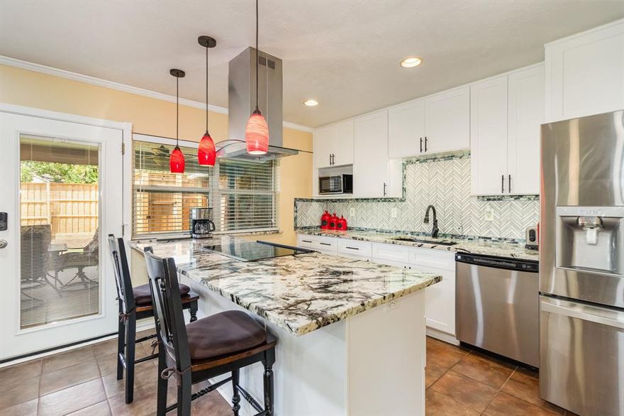 This terrific home is loaded with extras! Pride of ownership shows throughout. Spacious living room with vaulted ceiling, built in bookcase and wood burning fireplace, perfect for entertaining or spending time with family.  Beautiful remodeled kitchen with lux granite counters, custom backsplash, updated cabinets with undermount lighting, SS appliances and venthood. Kitchen is open to 2nd living area which also works great as a large dining area. Primary suite with 2 walk in closets and updated bath. Secondary bedrooms with mirrored closet doors and ceiling fans. Relax on the huge covered patio overlooking nice yard and new 8 ft fence. Updates include: windows, recessed LED lighting, bathroom vanities and tile work, crown moulding & more. Water heater, sprinkler system, thermostat, outdoor cameras, door locks all controlled remotely for convenience and energy efficiency. Great location near parks, TC Aquatic center, Lewisville Lake, Grandscape, The Star, Legacy and more! LISD schools.