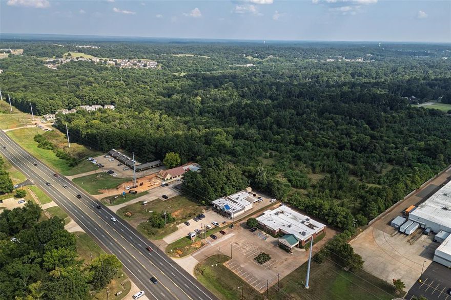 Positioned in one of the most desirable growth corridors of Nacogdoches, this 72.93± acre tract offers an exceptional opportunity for commercial, multi-family, or estate residential development. Located just east of Business 59 and south of NE Stallings Drive, the property’s strategic location places it at the heart of a high-demand area, surrounded by major retailers, established neighborhoods, and strong traffic counts. This tract is ideally suited for developers, investors, or individuals seeking a legacy estate property within the city limits of one of Texas’ most historically rich and economically vibrant communities.
The property features frontage along NE Stallings Drive with additional access via Roselake Drive, which serves as the side entrance to Walmart—its western neighbor—and connects to two other shopping centers to the south. Tenants in the immediate vicinity include Harbor Freight, Spec’s Wines, Spirits & Finer Foods, Hibbett Sports, and Great Clips, ensuring consistent consumer traffic and visibility.
To the south, the tract borders higher-end residential neighborhoods, offering the potential for estate-style home sites or a blended-use community that complements nearby housing demand. To the east lies the North Lanana Creek Trail, providing natural scenery and recreational appeal. The land itself offers a mix of gently rolling topography and open areas, making it adaptable to a variety of development layouts.
This 72.93± acre tract represents a rare opportunity to acquire a large parcel in the fastest-growing commercial and residential sector of Nacogdoches. With its combination of location, accessibility, and surrounding development, it is well-suited to a range of investment or end-user objectives. Whether your vision includes a commercial center, multi-family community, or an expansive private estate, this property offers the location and flexibility to bring it to life.