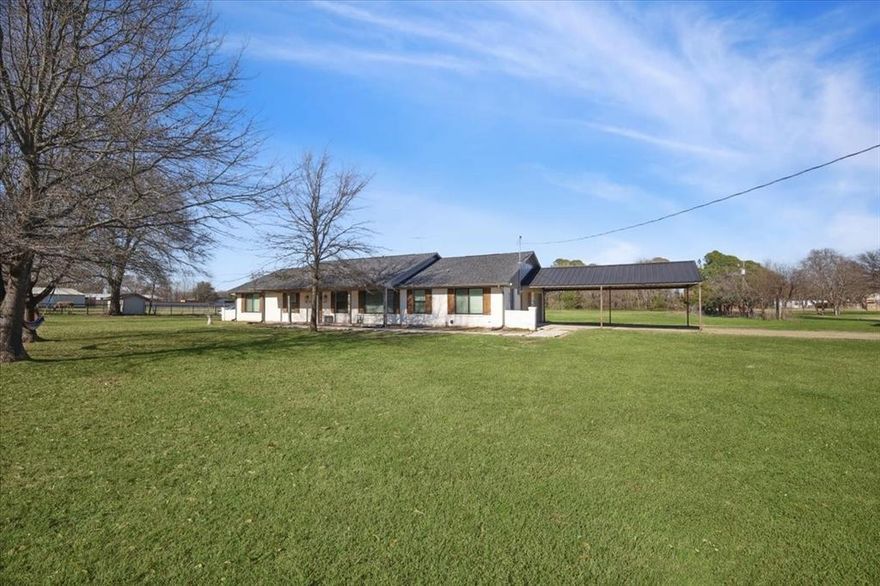 Rare opportunity to own 2.5 acres on a corner lot with no HOA, featuring a 20 x 30 workshop and plenty of space for RV parking, equipment, or hobbies. Located approximately 35 minutes from downtown Dallas, this property offers the perfect balance of space, privacy, and accessibility. Recent improvements include a new roof and septic system, providing peace of mind for the next owner. Interior features include vaulted ceilings with exposed wooden beam detail, custom-stained kitchen cabinetry, and a spacious laundry room with additional custom cabinetry for storage. The primary suite offers separate walk-in closets and a dedicated vanity area, creating a comfortable and functional retreat. Exterior highlights include an extended concrete patio, a two-car garage, and a covered carport with space for up to four additional vehicles. The 20 x 30 workshop with an automatic garage door opener provides additional space for storage, hobbies, or equipment. The expansive acreage offers ample room for outdoor living, gardening, or future improvements. Situated in a semi-rural setting, this property offers privacy, versatility, and the freedom of country living, while remaining within a 35-minute commute to downtown Dallas.
