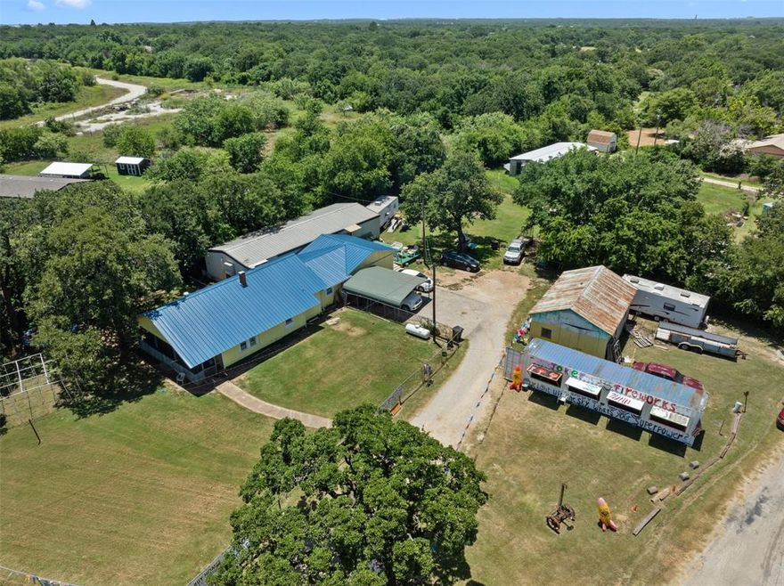 Hard corner out of the city limits! This is a prime spot for making the existing house and buildings into office space for a car lot or outdoor storage space business! 186' of road frontage on County Road 527 and 203' of road frontage on Renfro for a total of .898 acres! Bring your checkbook and imagination to this one!