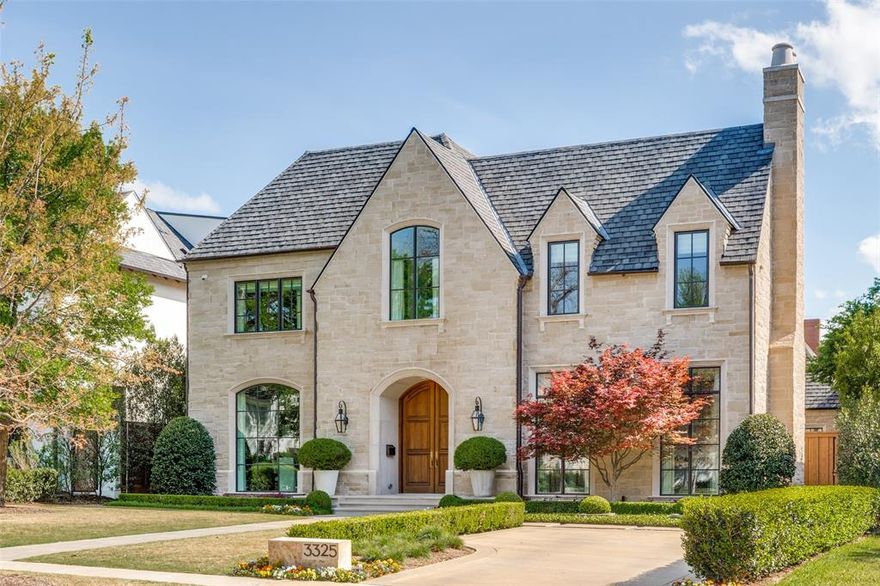 This timeless stone elevation home is situated on a 70x160 foot lot with a backdrop of lush landscaping, and beautiful hardwood doors that welcome you into a light filled, warm intentional home. Every detail shares the curated vision from the owners’ design choices and classic taste to withstand all seasons of architecture and interior finishes. The soaring foyer leads you into a quiet effortless grace. Floor to ceiling windows in the formals and the serene sitting room with fireplace welcomes comfort and retreat for a conversational sitting area or lovely workspace with French doors for privacy and quiet. As you move towards the heart of it all you find a beautiful, functional chefs’ kitchen with an inset breakfast nook complimented by a wall of windows overlooking the covered screened porch and tranquil back yard. The large living area allows for indoor outdoor living with sliding glass doors and patio with fantom screens for year around enjoyment. On the main level is the primary suite, rarely found in University Park homes. Complete with its own laundry room, where convenience meets understated luxury. Upstairs, reveals four en-suite bedrooms each with their own personality and offering comfort and cohesive elegance. The front room vaulted ceiling captures the light and is currently being used as an office and sitting space where ideas unfold and allows a comfortable way to work and lounge. A spacious game room at the end of the upstairs hallway includes a full bath and dual living design for play and lounging.  The flexible spaces adapt effortlessly for crafting, hobbies and workouts. Throughout the home, the consistency is classic, easy, and soft to enjoy living, playing, and relaxing.