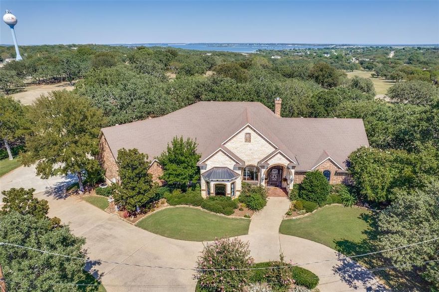 Welcome to this stunning custom home nestled at the end of a quiet cul-de-sac, perfectly positioned to offer breathtaking views of the golf course just beyond your backyard. This meticulously maintained residence combines timeless elegance with modern comfort, featuring 3 spacious bedrooms, 3 full bathrooms, and 3 convenient half baths.

From the moment you arrive, you'll be captivated by the oversized iron front door—an impressive statement that sets the tone for what’s inside. Step into the warm and inviting family room where a classic wood-burning fireplace becomes the heart of the home, ideal for cozy evenings or entertaining guests.

The thoughtfully designed kitchen is a chef’s dream, featuring a large center island with an electric range, a decorative vent hood, and a picturesque window above the sink that frames serene backyard views. Whether you're preparing meals or gathering with friends and family, this space blends function with charm.

The dedicated office offers both productivity and privacy, complete with elegant wood ceiling detail, custom built-ins, and double doors to keep your workday undisturbed.

Upstairs, the secondary bedrooms offer comfort and style, and one features access to a private balcony—perfect for morning coffee or enjoying the peaceful golf course setting at sunset.

The outdoor living spaces are equally impressive. The oversized covered patio is ideal for al fresco dining, relaxing, or simply soaking in the expansive views of the manicured fairways just beyond the fence line. It's a true extension of the home and a rare find in a setting like this.

This home offers the ultimate in privacy, luxury, and scenic living. With its premium cul-de-sac location, refined interior features, and direct golf course views, this property is a must-see for those seeking the perfect blend of comfort and sophistication.