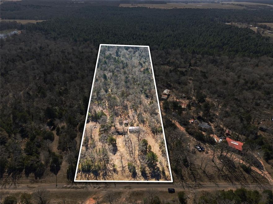 This 5 acre tract is ready for your manufactured home and offering privacy, usable space, and present or future potential. This tract backs up to Purtis Creek State Park and has a creek running through the back of the property. It has a mixture of many beautiful mature trees. It also provides a water well, propane gas tank, electric-completely new in 2025, septic, and recently added RV connectors. A portion of the yard is fenced in with a tall chain link fence. An existing slab with a remaining structure featuring a wood burning fireplace is connected by a breezeway to a storage building. Enjoy country surroundings while still being within reach of nearby towns, recreation, shopping, and dining. Hablo Espanol.