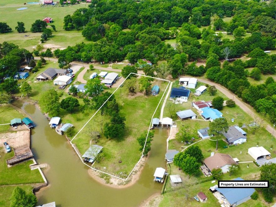 BRING ALL OFFERS!

Discover the perfect blend of tranquility and opportunity with this stunning almost one-acre waterfront property on Cedar Creek Lake. Boasting an impressive 307 feet of shoreline, this rare find offers expansive water views and endless potential for lakefront living.  Nestled among massive, mature trees, the property provides both privacy and natural beauty, creating a peaceful retreat from the everyday. A two-boat boathouse makes it easy to enjoy everything the lake has to offer, from early morning fishing to sunset cruises. The existing approximately 720-square-foot cabin offers immediate usability—ideal as a weekend getaway, guest space, or temporary residence while you design and build your dream lake home. With its generous lot size and prime waterfront location, this property is a blank canvas ready for your vision.
Enjoy the freedom and flexibility of NO HOA, giving you the ability to truly make this property your own without added restrictions.