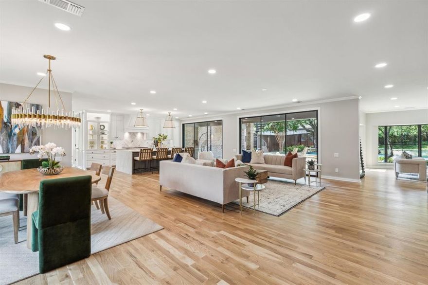 When you open the iron double doors, you can't help but pause to take in the open space with lots of natural light & views. Natural white oak floors flow continuously between the dining, living, sun room, kitchen & breakfast room. The dining room features gorgeous windows & a designer chandelier. A wall of sliding doors to the backyard offer views & access to the covered porch & backyard. An electric fireplace offers ambiance. The sunroom with wet bar offers an intimate place to gather. The kitchen is at the heart of the home featuring separate prep areas for multiple chefs to move easily through the kitchen. A huge island is a work of art as well as function. A Wolf gas range, Sub-Zero refrigerator, Bosch dishwasher, a walk-in pantry & tons of storage complete the space. One of the best features is the elevator! Owner privacy prevails with all sleeping rooms up, plus a game room with a wet bar & balcony with spiral stairs to the pool. So many updates to easily just move in and enjoy!