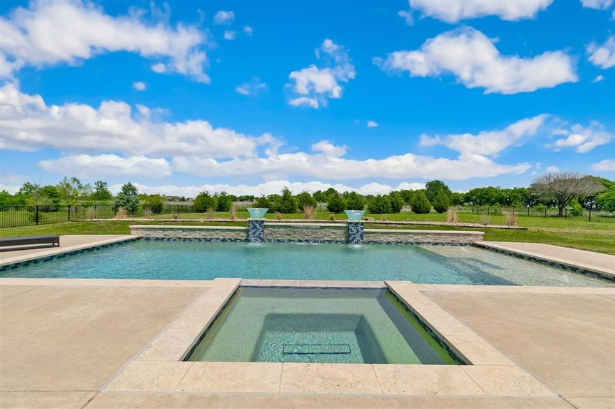 Welcome to a stunning Country French-style luxury estate, entertaining galore in an exclusive gated community. Situated on a fully fenced 1-acre lot with NO CITY TAXES, this exceptional home features 5 spacious bedrooms, 4 baths, and a thoughtfully designed layout perfect for both everyday living and hosting unforgettable gatherings.
Step inside to discover an elegant open-concept design with a grand living area featuring a built-in bar, ideal for entertaining. The luxurious primary suite offers a spa-inspired bathroom and his-and-hers walk-in closets. Upstairs, enjoy a versatile game room, a media room that can easily serve as a mother-in-law suite, and an additional wet bar for the ultimate entertainment experience.
Step outside into your private backyard oasis—complete with a saltwater pool and spa, tanning ledges, and an extended covered patio perfect for year-round enjoyment. A charming courtyard adds even more space to relax and entertain under the Texas sky.
And let’s not forget the views—enjoy peaceful sunrises from upstairs windows and breathtaking sunsets from your own backyard retreat. This home seamlessly blends luxury, comfort, and lifestyle, making it a rare opportunity for buyers seeking space, privacy, and upscale living in North Texas.
